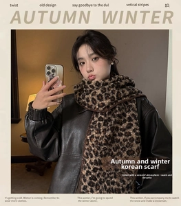 Detail of leopard print faux wool scarf paired with a black leather jacket for winter