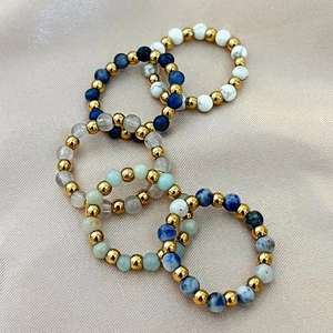Five-piece elastic beaded ring set with natural stones and gold-tone beads on silk
