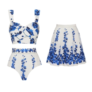 Detailed view of three-piece swimsuit with blue floral print and matching mini skirt