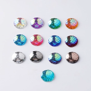Close-up of 14mm round resin fish scale cabochons in various iridescent colors