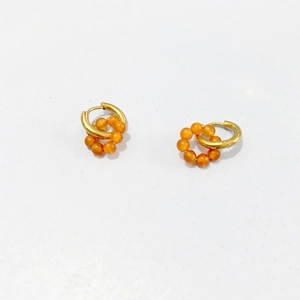 Detailed close-up of 18K gold stainless steel hoop earrings with orange natural stone beads
