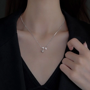 Elegant S925 sterling silver rose pendant necklace with sparkling leaves on a female model