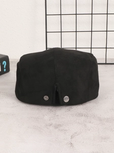 Close-up of black suede ivy cap back showing adjustable metal buckle and texture