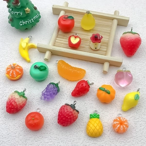 Detailed view of colorful resin fruit pendants with metal loops for DIY jewelry making