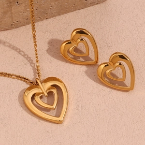 Detailed view of the 18K gold plated hollow heart necklace and matching stud earrings set