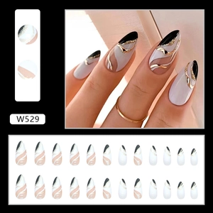 Detail of almond-shaped press-on nails with white French tips and gold foil marble art