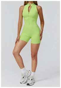 Close-up of bright neon green yoga romper showing the front zipper and slim fit cut