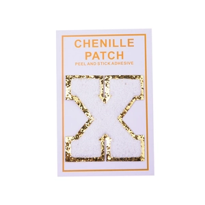 Detail of chenille letter X patch with gold glitter edge and peel-and-stick backing
