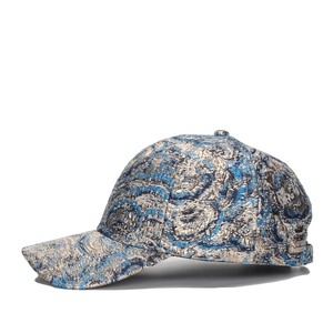 Fashion baseball cap featuring blue and gold jacquard swirl pattern on a white background