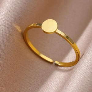 Minimalist gold-plated stainless steel open ring with a round disc on silk fabric