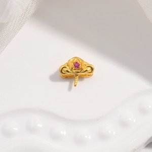 Detailed macro of gold S925 silver pendant holder with pink zircon in floral design