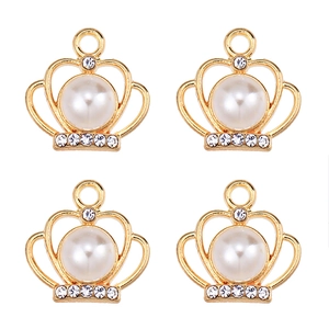 Close-up of four golden crown pendants with white pearls and clear cubic zirconia stones