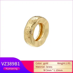 Gold-plated brass spacer bead featuring hollow evil eye and cross geometric pattern