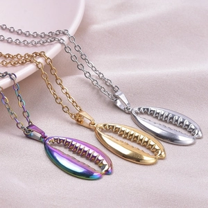 Detailed view of three shell pendant necklaces in rainbow, gold and silver finishes