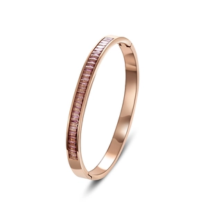 Rose gold titanium bangle featuring a row of rectangular cut purple sparkling stones