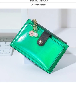 Macro view of bright green patent leather card holder with flower pearl charm and zipper