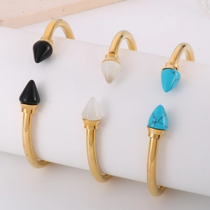Gold stainless steel C-shaped bracelets with turquoise, white, and black cone studs