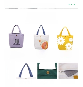 Detail of canvas tote bags showing screen print, colorful handles and copper snap buttons