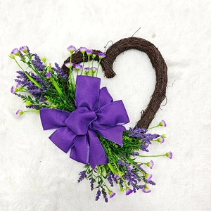 Brown heart-shaped rattan wreath with purple lavender flowers and large fabric bow