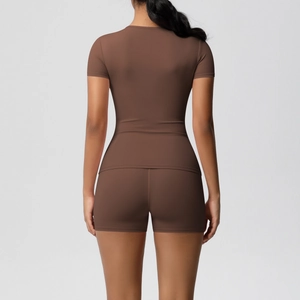 Women's brown two-piece yoga set with short sleeve top and tight high-stretch shorts back view