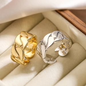 Minimalist gold and silver geometric chain link open rings on beige velvet jewelry box