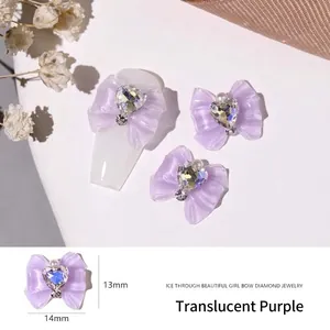 Detail of translucent purple bow nail charm with heart rhinestone and 13x14mm dimensions
