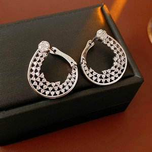 Macro shot of silver plated flower hoop earrings with sparkling micro-set cubic zirconia