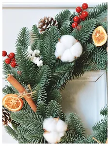 Detail of Christmas wreath with pine needles, cotton, pine cones and cinnamon sticks
