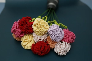 Detail of handcrafted crochet carnation bouquet with multi-color lace yarn flowers