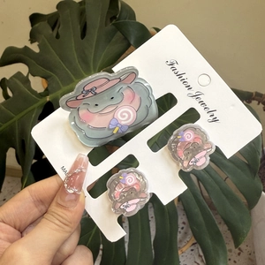 Cute blue acrylic hippo hair clip and matching earrings set on fashion jewelry card