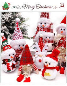 Detailed view of plush Christmas snowman and gnome dolls for festive floral decoration