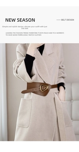 Detail of wide brown leather belt featuring a modern golden triangle metal buckle