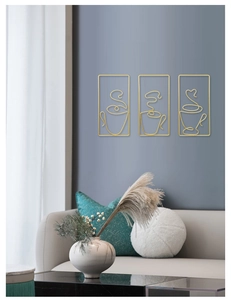 Detail of three-piece gold metal line art coffee cup wall decor in modern living room