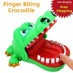 Close-up of a green crocodile biting finger toy showing interactive teeth pressing
