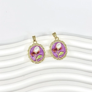 Detailed macro view of vintage baroque gold pendants with purple enamel and pearl floral inlay