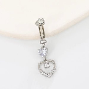 Detail of silver heart-shaped navel clip featuring sparkling rhinestones and crystals