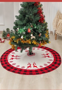 Close-up of a 48-inch knitted Christmas tree skirt with red reindeer and snowflake patterns
