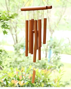 Detailed close-up of a handmade bamboo wind chime featuring multiple tubes in nature