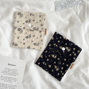 Detailed macro view of floral cotton fabric pouches with round resin snap button closure