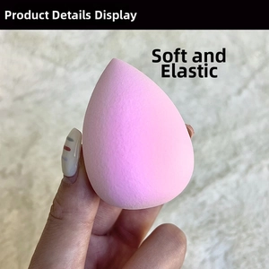 Close-up of a pink teardrop makeup sponge showing its soft texture and high elasticity