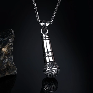 Detailed view of hip hop microphone pendant with intricate mesh texture and silver finish