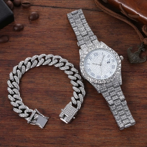 Macro detail of silver iced-out watch and Cuban link bracelet set with Roman numerals