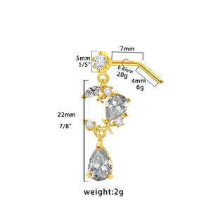 Detail view of a gold nose stud with moon and star zircon pendants and dimension labels