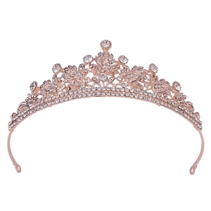 Detailed view of rose gold bridal crown with crystal flower and leaf pattern