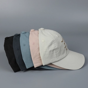 Detail of artistic letter embroidery on a washed cotton soft-top baseball cap