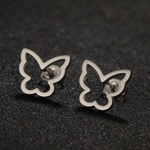 Macro shot of minimalist hollow butterfly stud earrings with polished metal finish