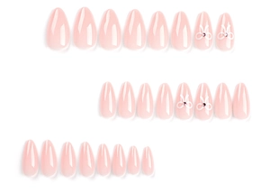 Detail of short oval press-on nails in nude pink with white 3D bows and purple rhinestones