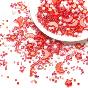 Macro detail of red and white DIY bead set featuring stars, moons and assorted round beads