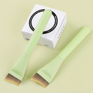 Dual ultra-thin foundation brushes with light green handles and soft fiber bristles