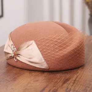 Elegant camel wool beret hat with gold satin bow, rhinestone brooch and vintage mesh veil